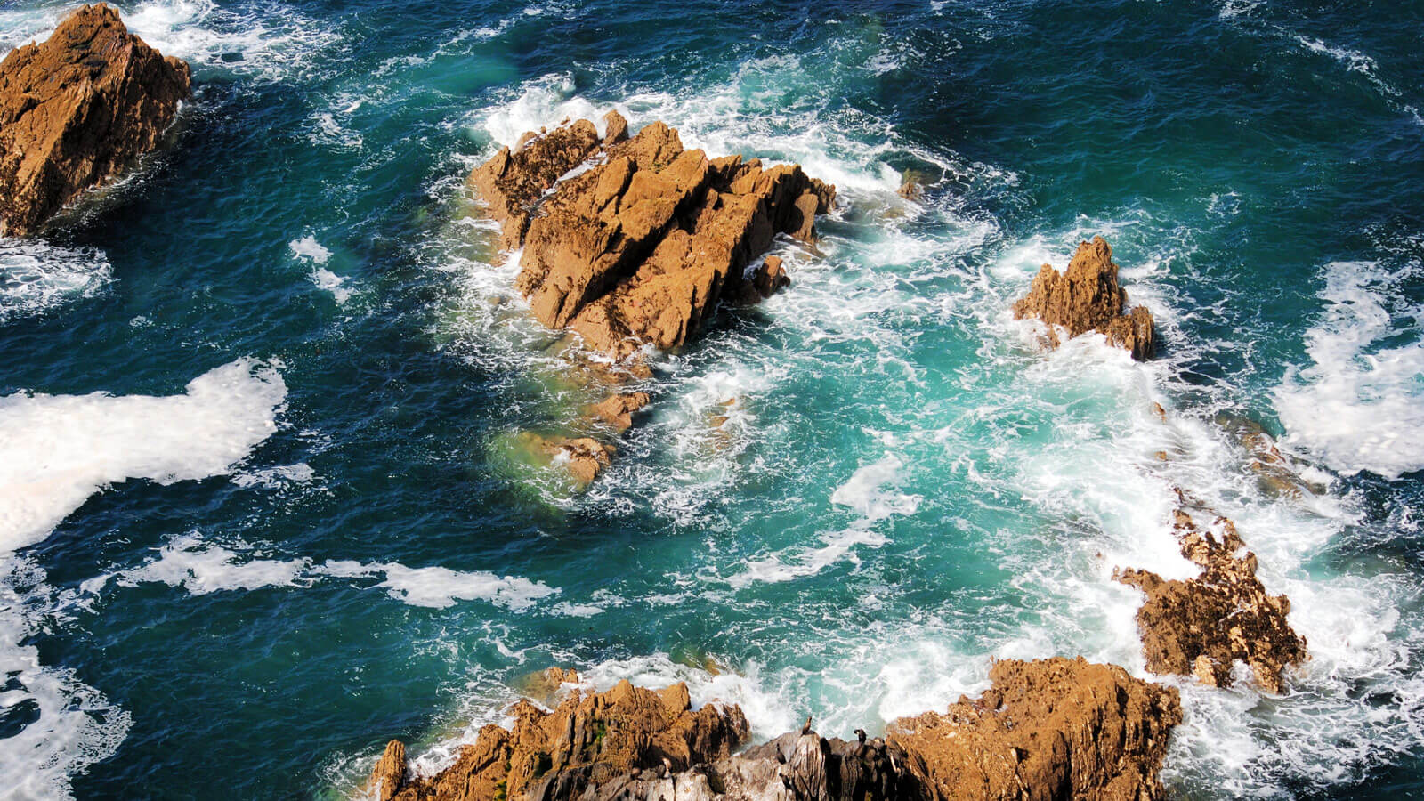 Rocky Sicilian coastline with clear water near Sant'Elia